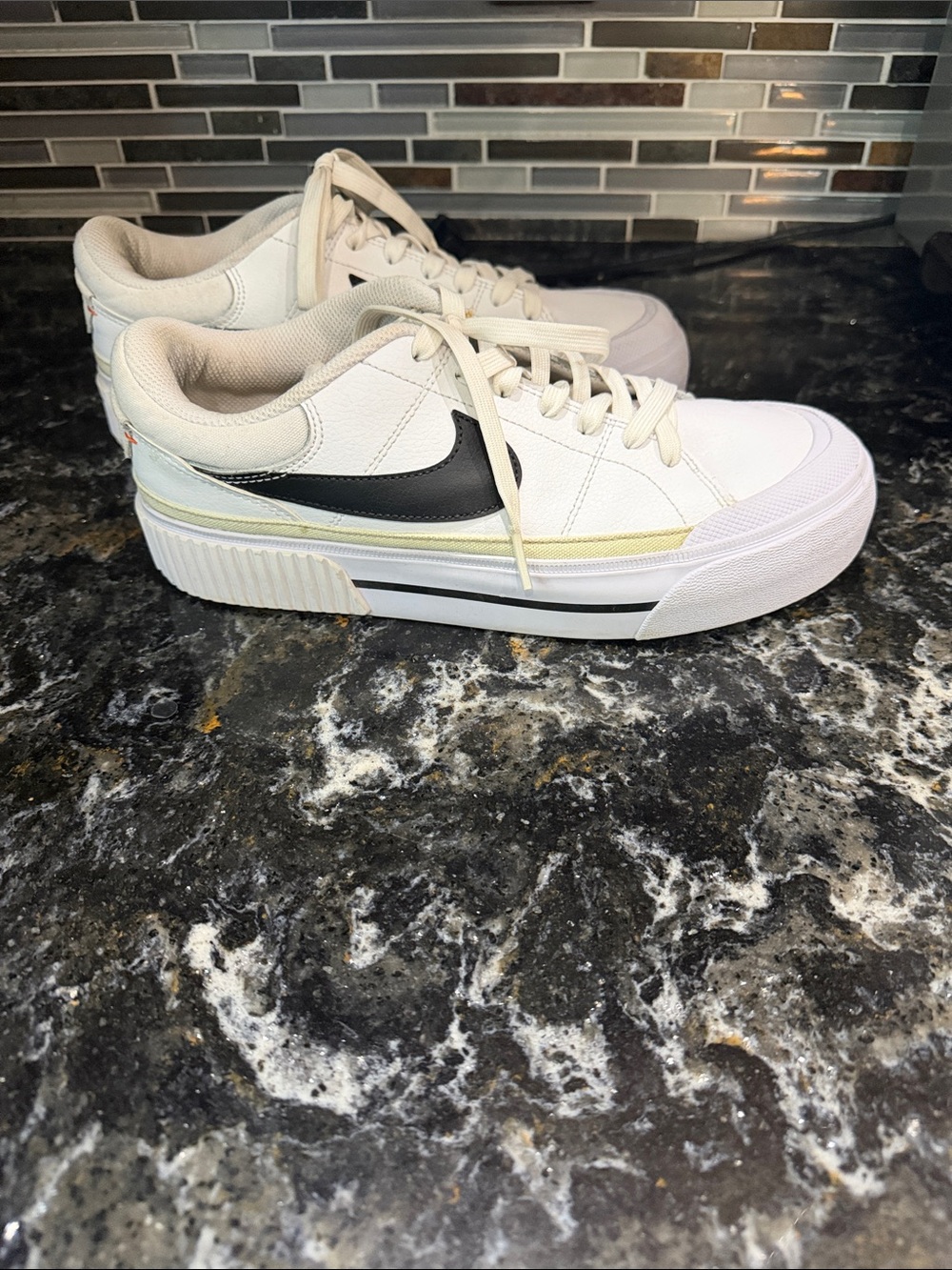 Nike White Low-Top Sneakers with Black Swoosh and Pale Yellow Accent